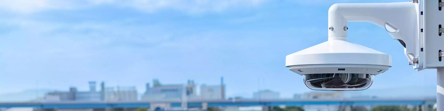 CCTV camera on a clear blue sky background
